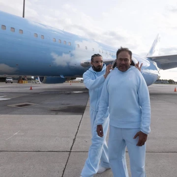 Drake NOCTA Nike Tech Fleece in front of Air Drake