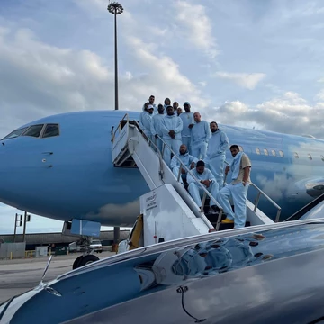 Drake NOCTA Nike Tech Fleece with the Crew in front of Air Drake