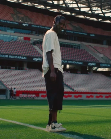 Travis Scott in a Stadium with the Jordan Cut The Check on Feet