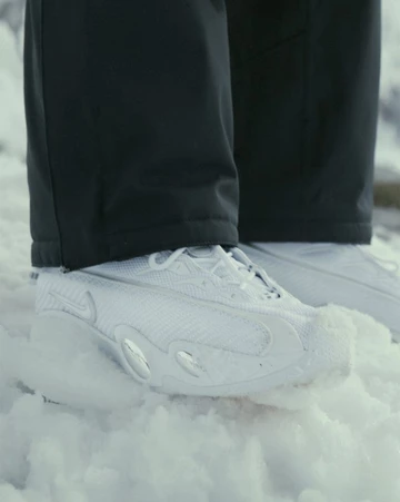 NOCTA Nike Glide White Chrome on feet im schnee