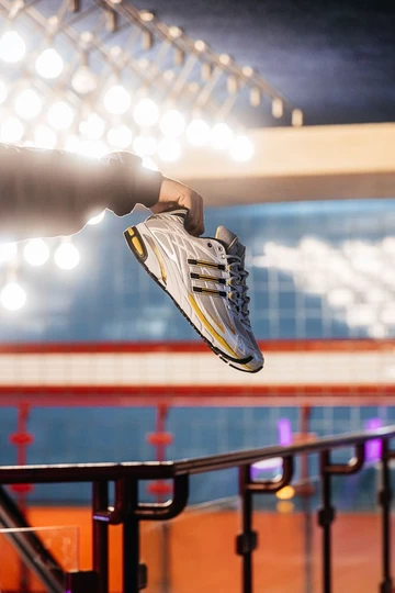 adidas Adistar Cushion 3 Gold Metallic Christopher hält den Schuh in der hand